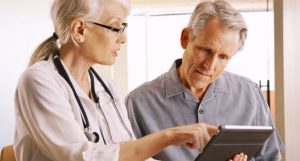 patient doctor looking at tablet
